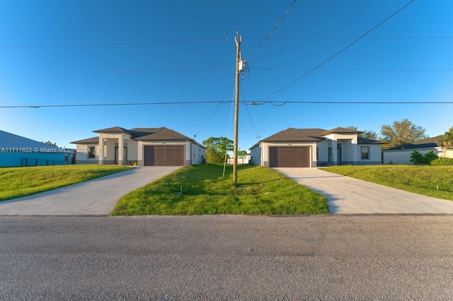 view of front of property with a garage and a front lawn