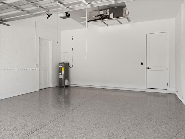 garage featuring electric water heater and a garage door opener