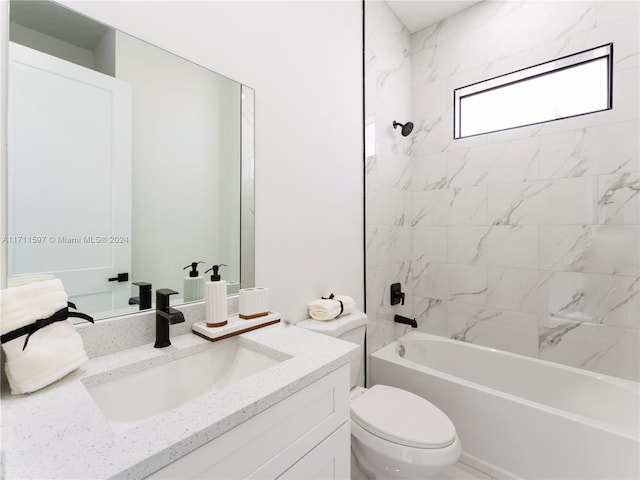 full bathroom with vanity, tiled shower / bath combo, and toilet