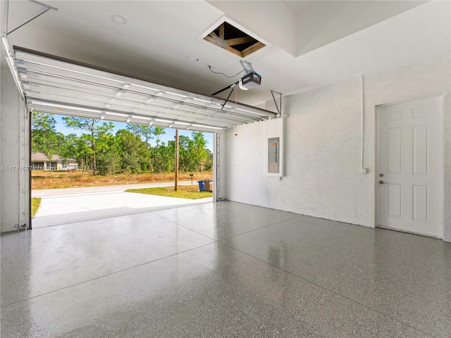 garage featuring electric panel and a garage door opener