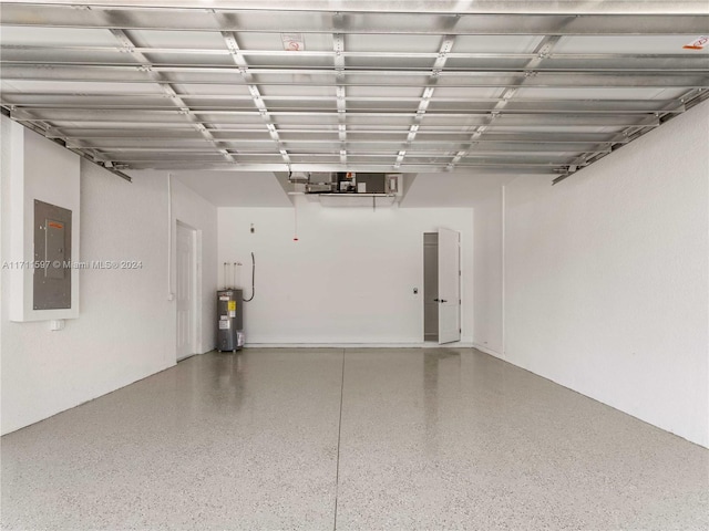 garage featuring electric panel and water heater