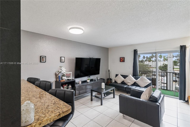 living room with light tile patterned flooring and a textured ceiling