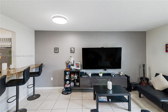 living room featuring light tile patterned floors and a textured ceiling