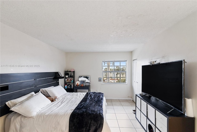 tiled bedroom featuring a textured ceiling