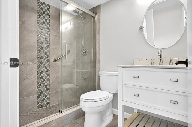 bathroom featuring tile patterned floors, vanity, toilet, and walk in shower