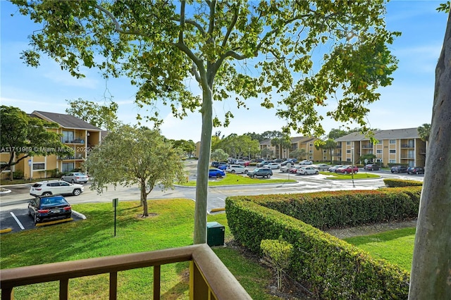 exterior space with uncovered parking, a yard, and a residential view