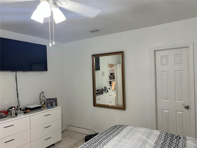 tiled bedroom with ceiling fan