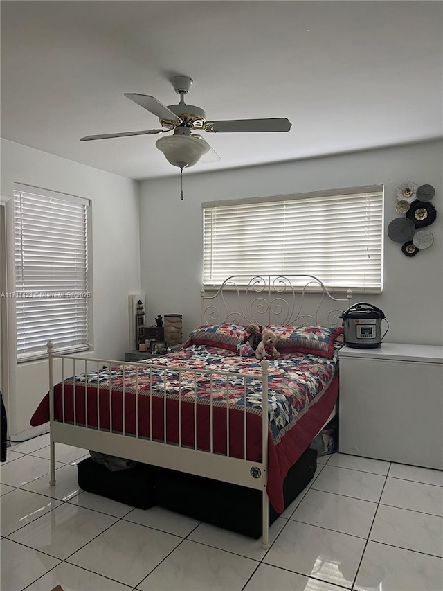 tiled bedroom with ceiling fan