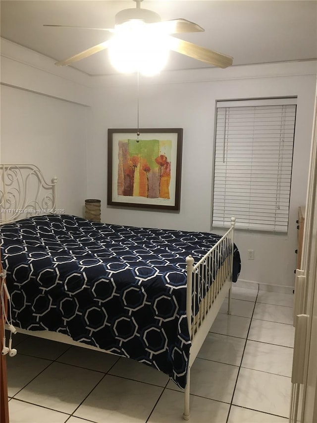 tiled bedroom featuring ceiling fan