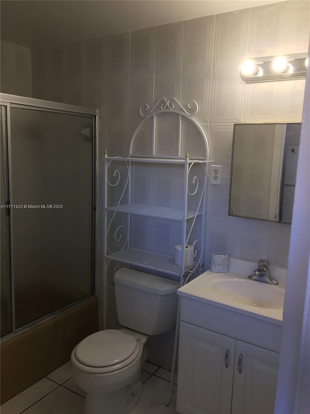 full bathroom with toilet, vanity, tile patterned flooring, and shower / bath combination with glass door