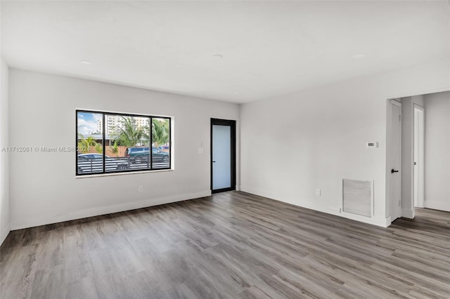 unfurnished room with hardwood / wood-style floors