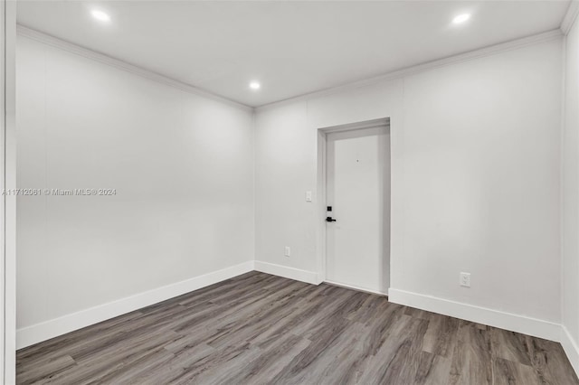 unfurnished room featuring dark hardwood / wood-style flooring and crown molding