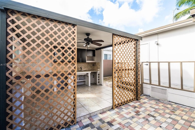 view of patio / terrace featuring ceiling fan and radiator heating unit