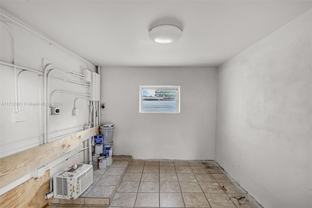 washroom with a wall mounted air conditioner and electric dryer hookup