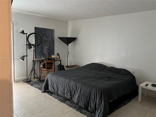 bedroom with light tile patterned floors and a textured ceiling