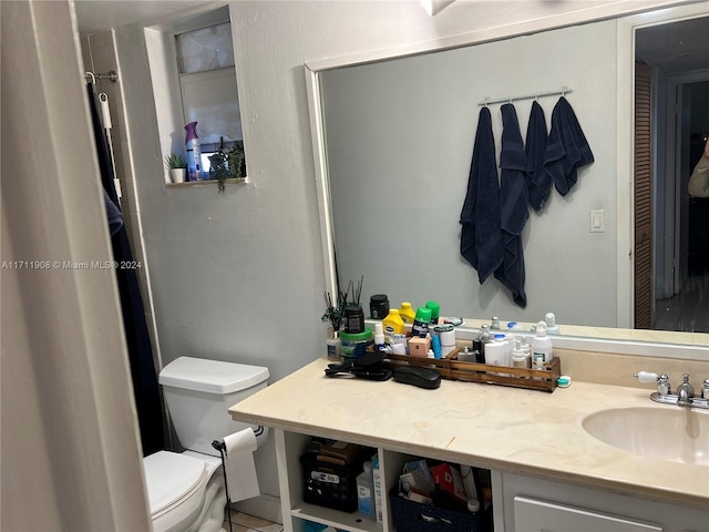 bathroom featuring vanity and toilet