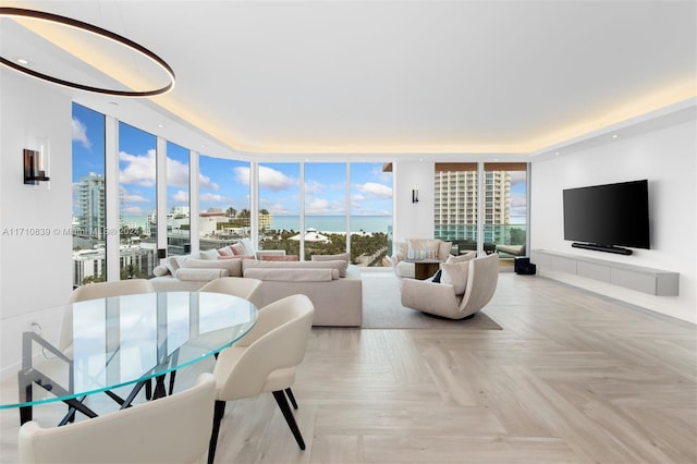 living room featuring light parquet flooring and floor to ceiling windows