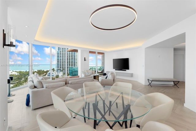 living room with expansive windows, a wealth of natural light, and light parquet flooring