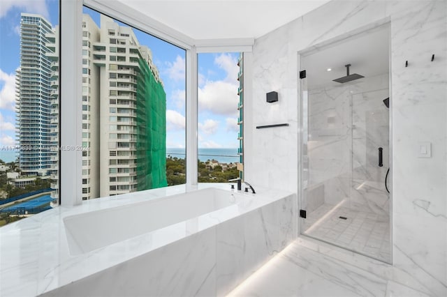 bathroom with a water view and independent shower and bath