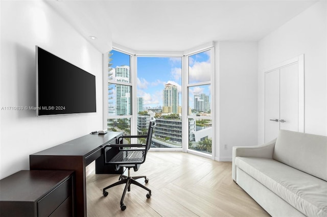 home office featuring plenty of natural light and light parquet floors