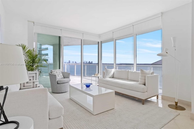 living room featuring tile patterned flooring and a water view