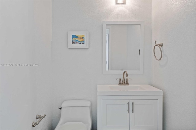 bathroom featuring vanity and toilet