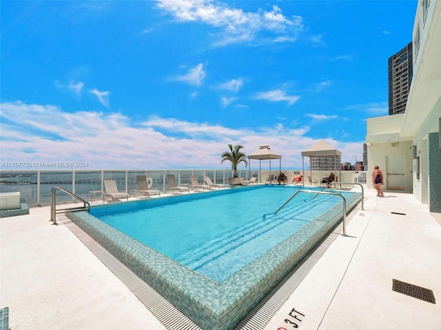 view of swimming pool with a patio