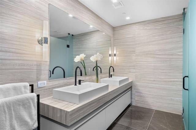 bathroom featuring vanity, tile walls, and walk in shower