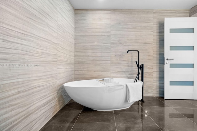 bathroom featuring a tub to relax in and tile walls