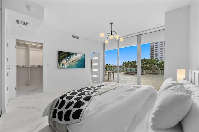 bedroom featuring floor to ceiling windows, a closet, access to exterior, a spacious closet, and a chandelier