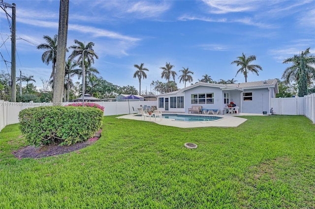 exterior space with a fenced in pool and a patio