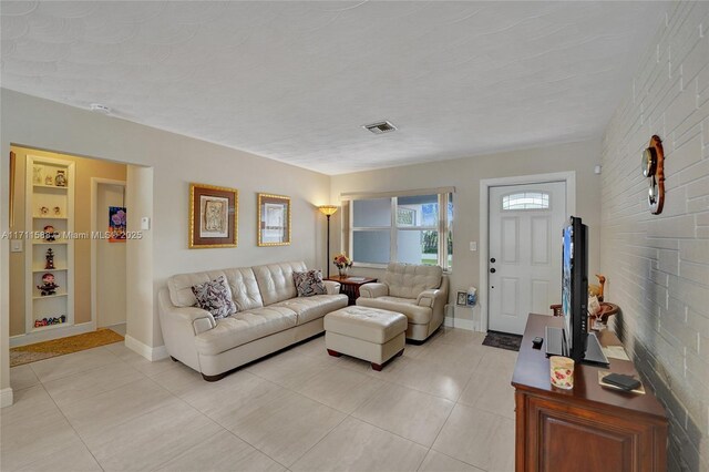 living room featuring ceiling fan and a textured ceiling