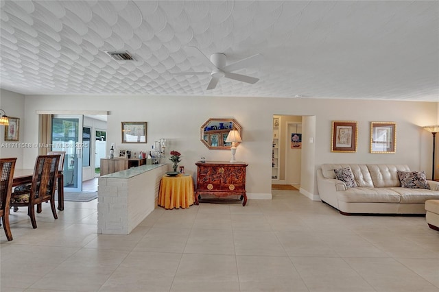 1407 Harding St, Hollywood, FL 33020 - living area featuring a ceiling fan, a textured ceiling, light tile patterned floors, baseboards, and visible vents