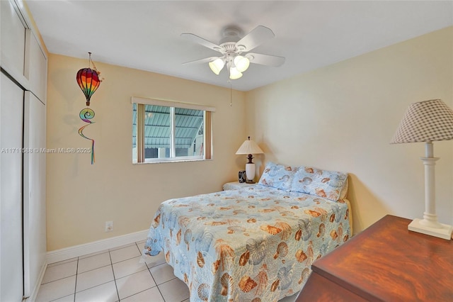 tiled bedroom featuring a closet and ceiling fan