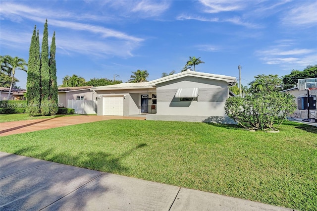 single story home featuring a front lawn and a garage