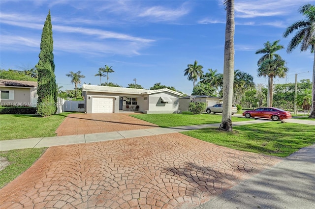 ranch-style house with a front yard and a garage