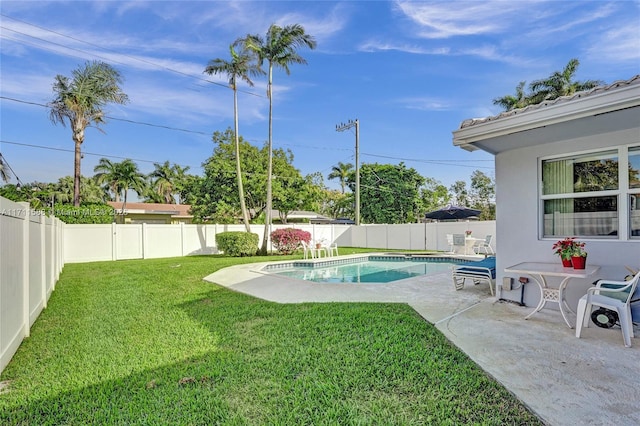 view of swimming pool featuring a yard and a patio