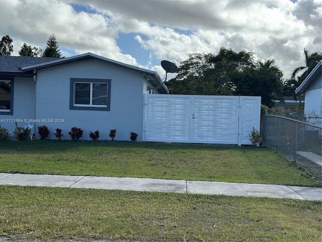 view of property exterior with a lawn