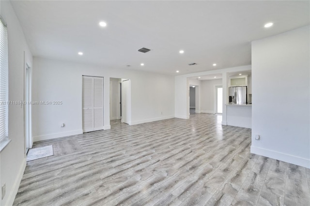 unfurnished living room featuring light hardwood / wood-style floors