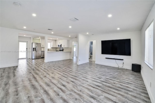 unfurnished living room with light hardwood / wood-style flooring