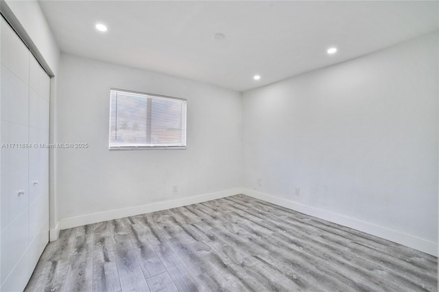 spare room with light hardwood / wood-style floors