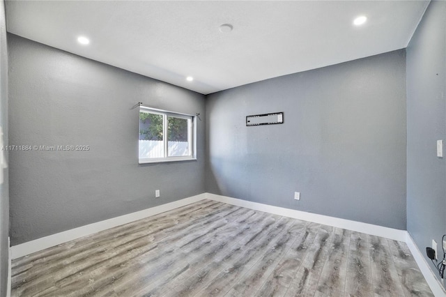 unfurnished room with light wood-type flooring