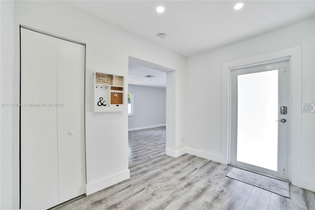 foyer entrance with light hardwood / wood-style flooring