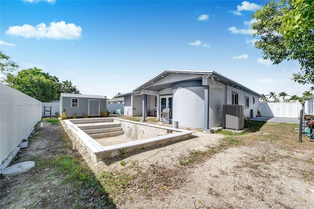 back of property with cooling unit and a storage unit