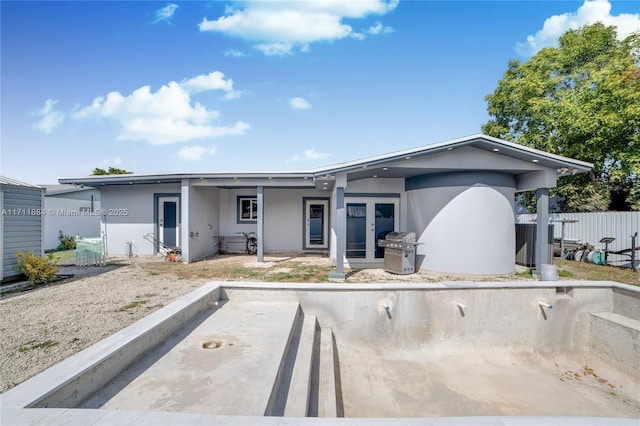 rear view of property featuring french doors