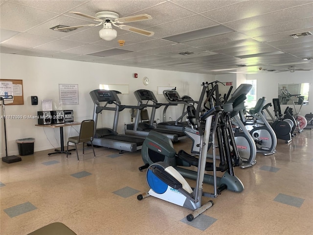 gym featuring a paneled ceiling and ceiling fan