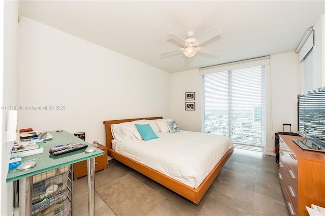 bedroom featuring expansive windows and ceiling fan