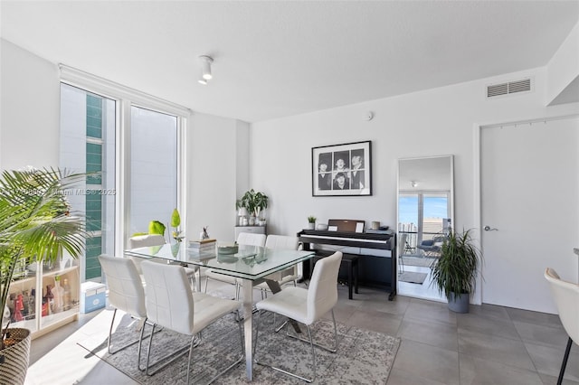 dining space with tile patterned flooring and visible vents