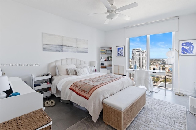 bedroom with a view of city, a ceiling fan, and access to exterior