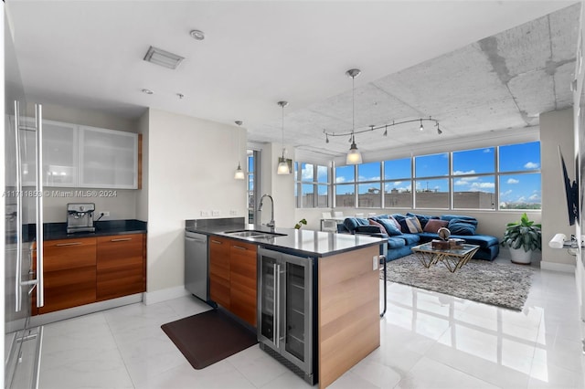 kitchen with a wealth of natural light, stainless steel dishwasher, beverage cooler, and sink